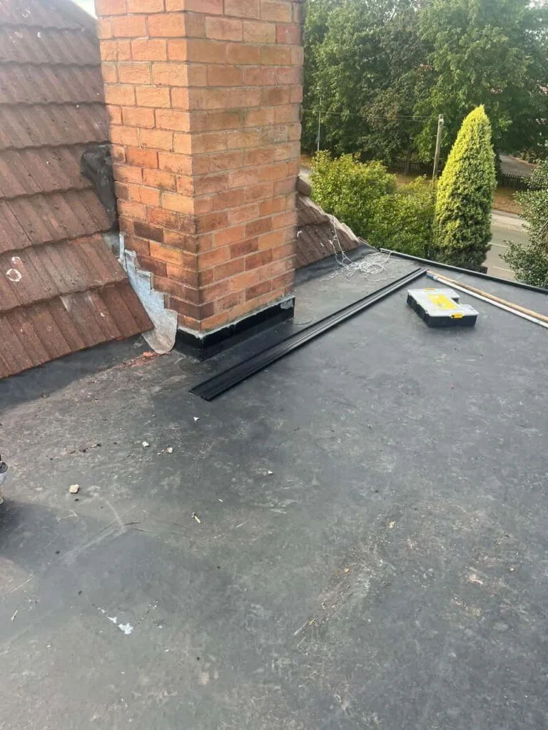 This is a photo of a flat roof which has just been repaired, there is also a chimney stack and some leadwork has also been dressed. Works carried out by Chatteris Roofing Repairs